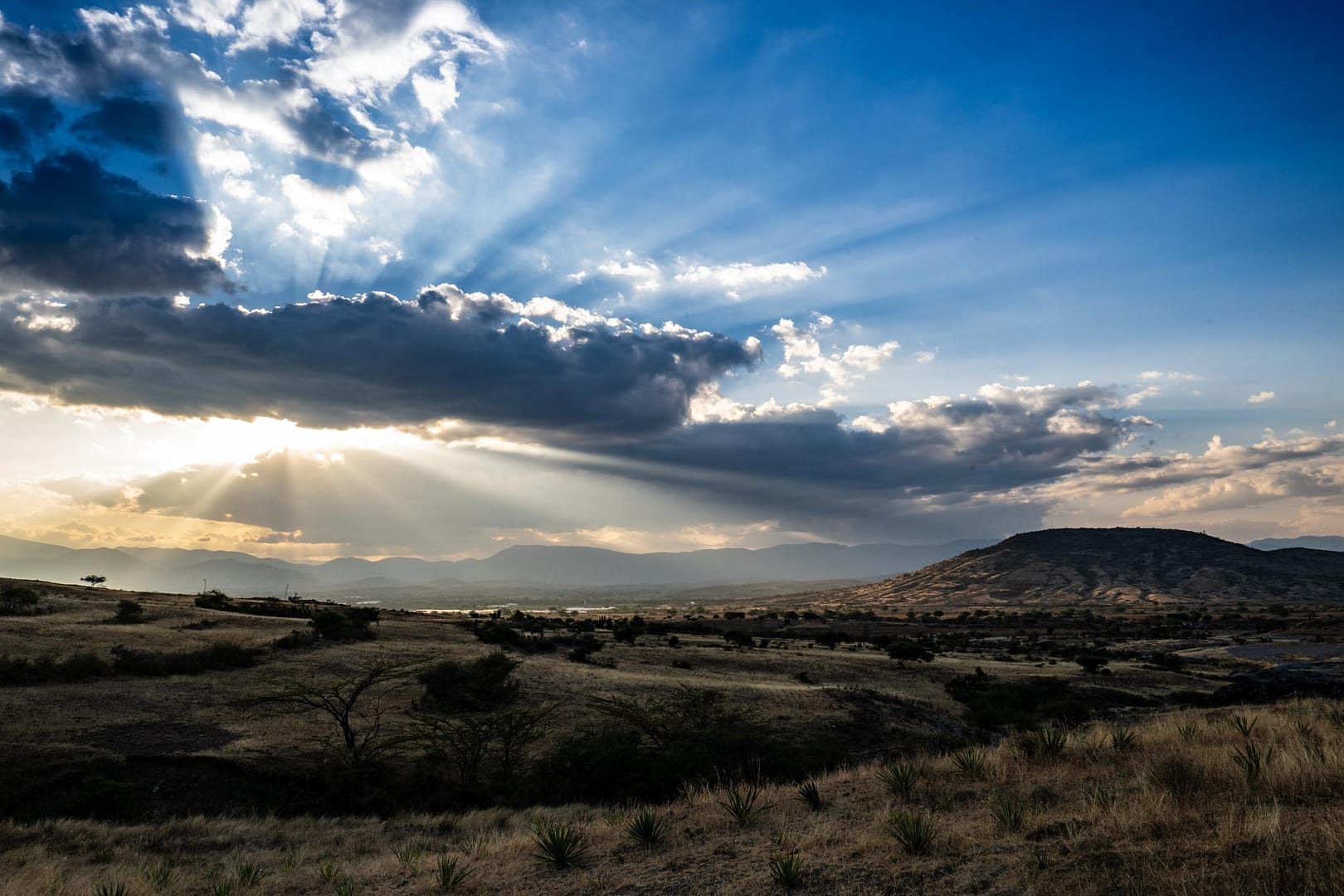Photograph by Chris Rank as the sun sets over a valley Oaxaca, Mexico